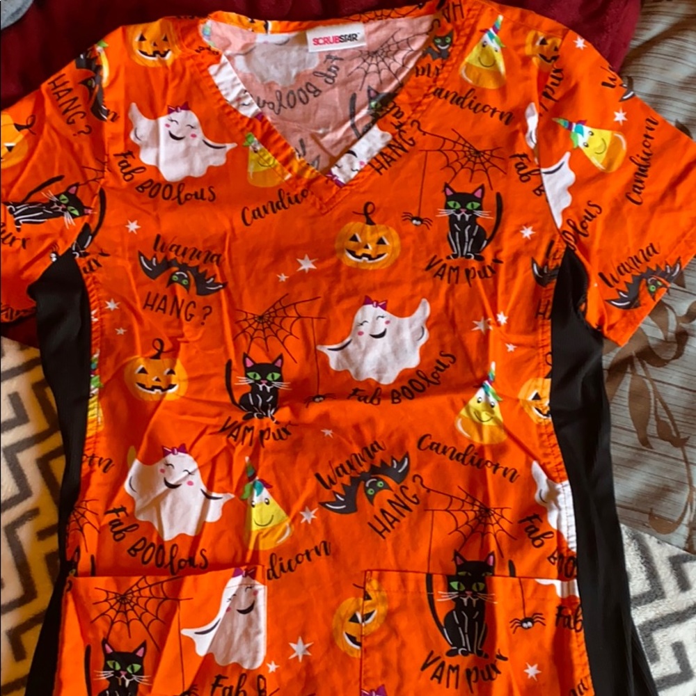 Three scrub shirts